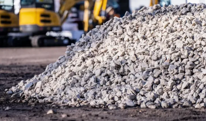 Eco-Match mobile crushing and screening plant producing aggregate on a remote wind farm, turbines on the ridge